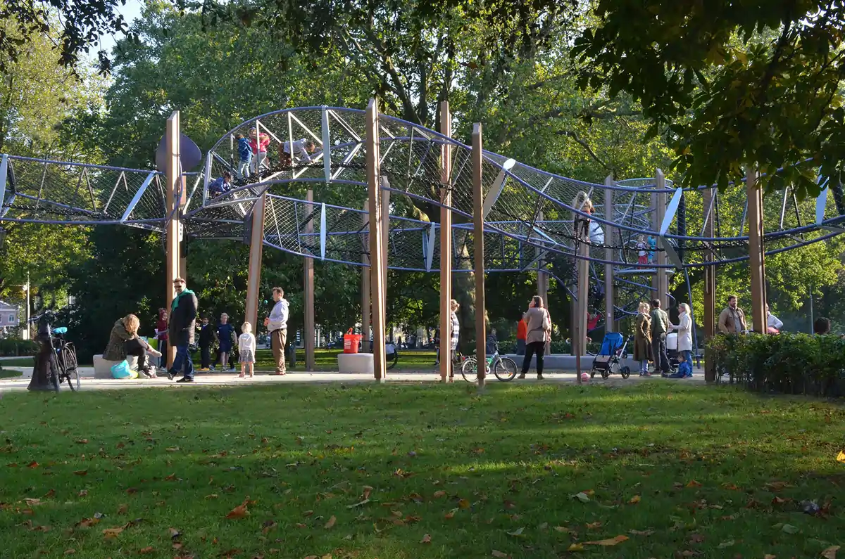 Playground and benches shaded by plane trees in Frederik Hendrikplantsoen park, Jordaan district, Amsterdam.